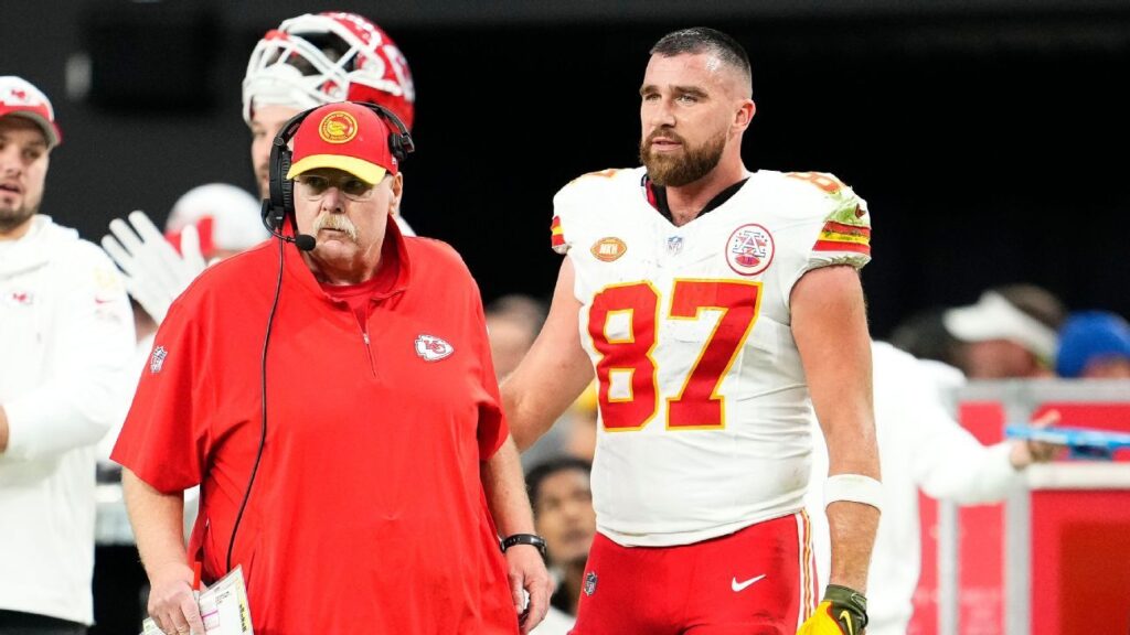 Kansas City Chiefs head coach Andy Reid smiling on the sidelines while wearing a team cap and headset