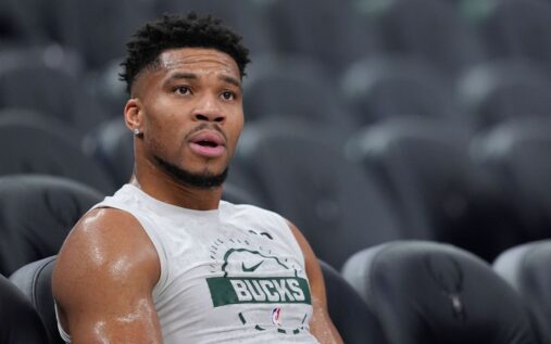 Giannis Antetokounmpo in a Milwaukee Bucks jersey looking focused on the court during an NBA game