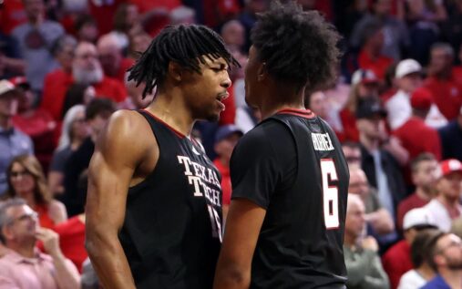 JT Toppin of Texas Tech driving to the basket against Arizona defenders during the overtime victory in Tucson