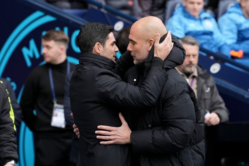 Mikel Arteta issuing instructions to Arsenal players on the touchline during a Premier League match.