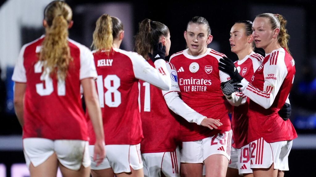 Arsenal striker Alessia Russo celebrating a goal against OH Leuven in the rain at Meadow Park