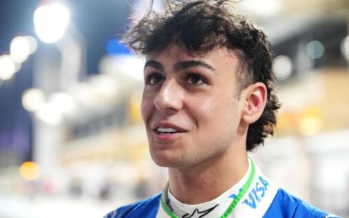 Arvid Lindblad wearing Racing Bulls team kit looking contemplative on a beach in Bahrain