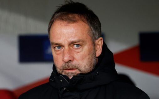 Barcelona players look dejected on the pitch as Atletico Madrid celebrate a goal in the background