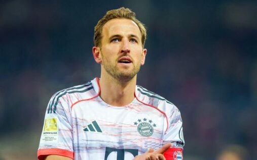Harry Kane acknowledging fans while wearing a Bayern Munich shirt