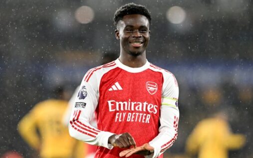 Bukayo Saka celebrating an Arsenal goal by mimicking signing a contract with his hand