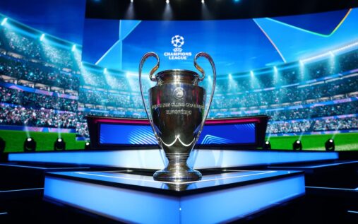 The UEFA Champions League trophy displayed on a podium during a draw ceremony in Nyon