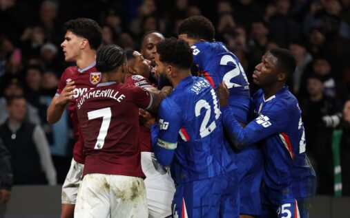 Referee attempting to separate Chelsea and West Ham players during a mass confrontation on the pitch