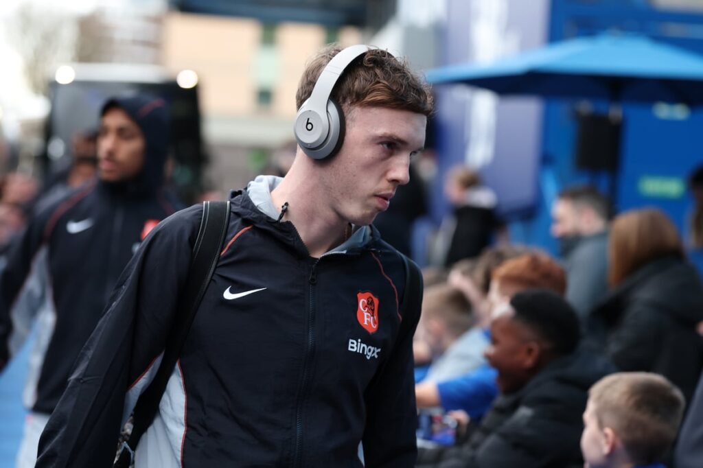 Cole Palmer looking focused on the pitch while wearing a Chelsea kit during a Premier League match