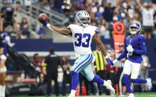 Javonte Williams running with the ball in a Dallas Cowboys uniform during an NFL game