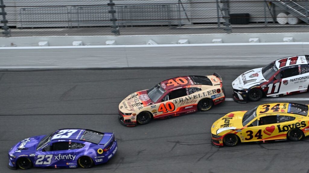 Denny Hamlin's car spinning into the infield grass at Daytona International Speedway during a multi-car crash