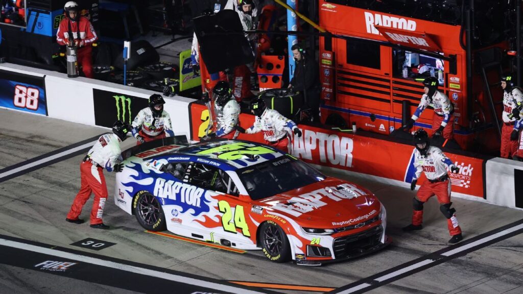 William Byron standing on the grid next to his No. 24 Chevrolet at Daytona International Speedway