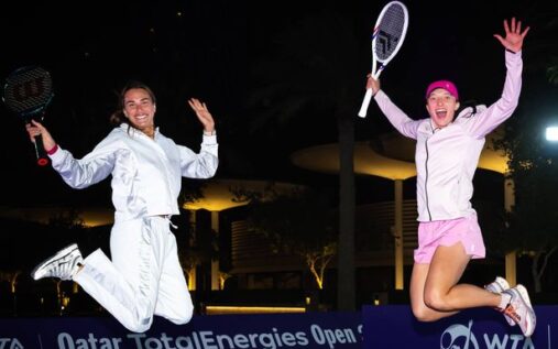 Aryna Sabalenka and Iga Swiatek standing on a tennis court during a trophy presentation
