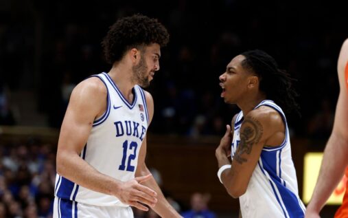 Duke Blue Devils head coach Jon Scheyer giving instructions to Cameron Boozer during a game