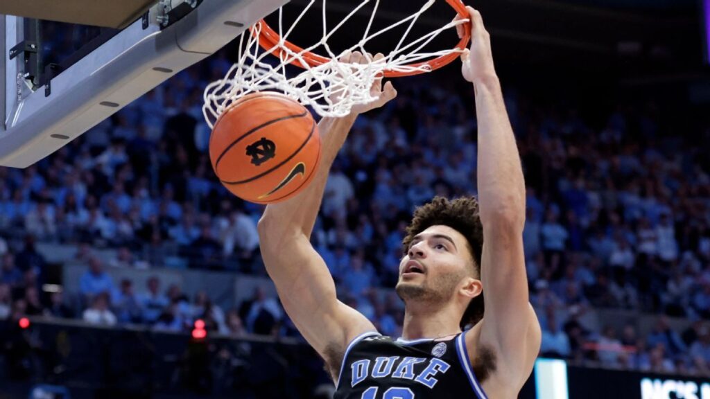 Duke players celebrating on the court after securing a victory against Michigan