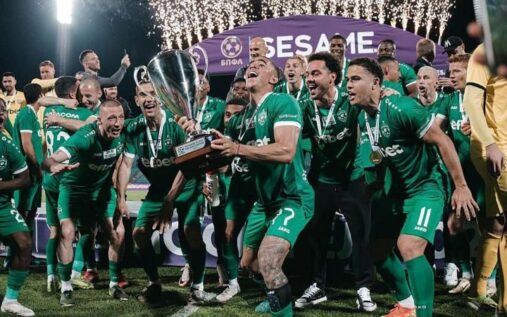 The Champions League trophy displayed on a pedestal during a European football match evening