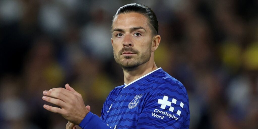 Jack Grealish clapping the fans while wearing an Everton shirt during a Premier League match