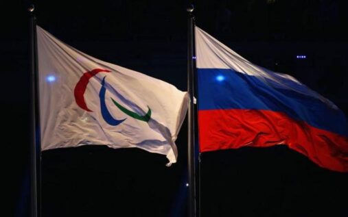 A visually impaired skier competing in the slalom event at a winter para-sports competition