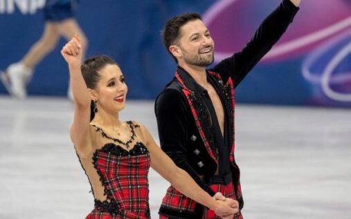 Lilah Fear and Lewis Gibson performing their ice dance routine in colourful outfits at the Winter Olympics