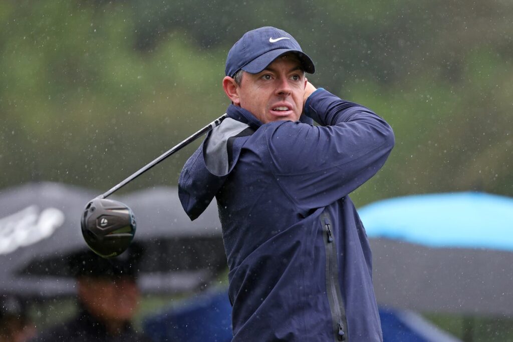 Rory McIlroy playing a shot in wet conditions at the Genesis Invitational