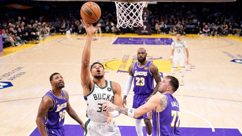 LeBron James and Luka Doncic talking on the court during a Los Angeles Lakers game