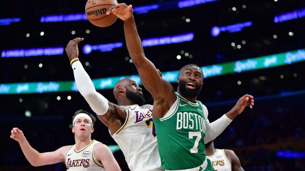 Jaylen Brown driving to the basket while being defended by LeBron James during the Celtics vs Lakers game