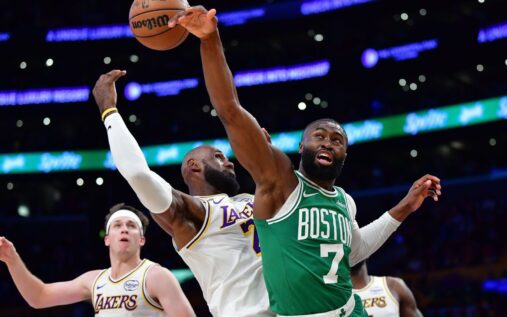 Jaylen Brown driving to the basket while being defended by LeBron James during the Celtics vs Lakers game