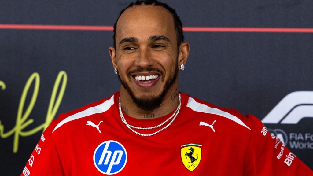 Lewis Hamilton wearing Ferrari team kit walking in the paddock during pre-season testing in Bahrain