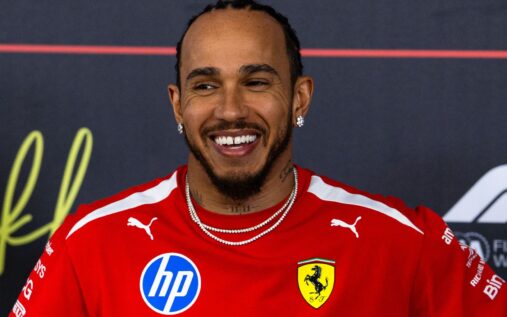 Lewis Hamilton wearing Ferrari team kit walking in the paddock during pre-season testing in Bahrain