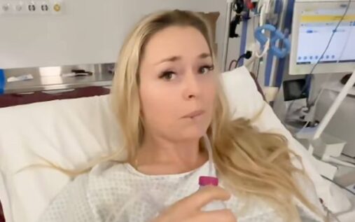 Lindsey Vonn wearing a ski helmet and goggles looking focused on the slopes before a race