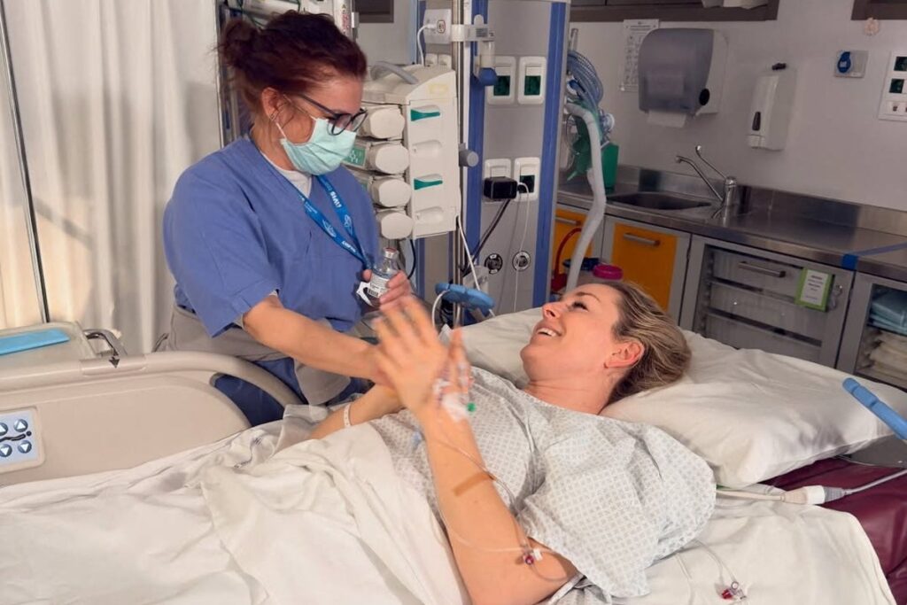 Lindsey Vonn looking focused in her racing helmet and goggles before a downhill skiing event