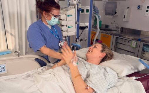 Lindsey Vonn looking focused in her racing helmet and goggles before a downhill skiing event