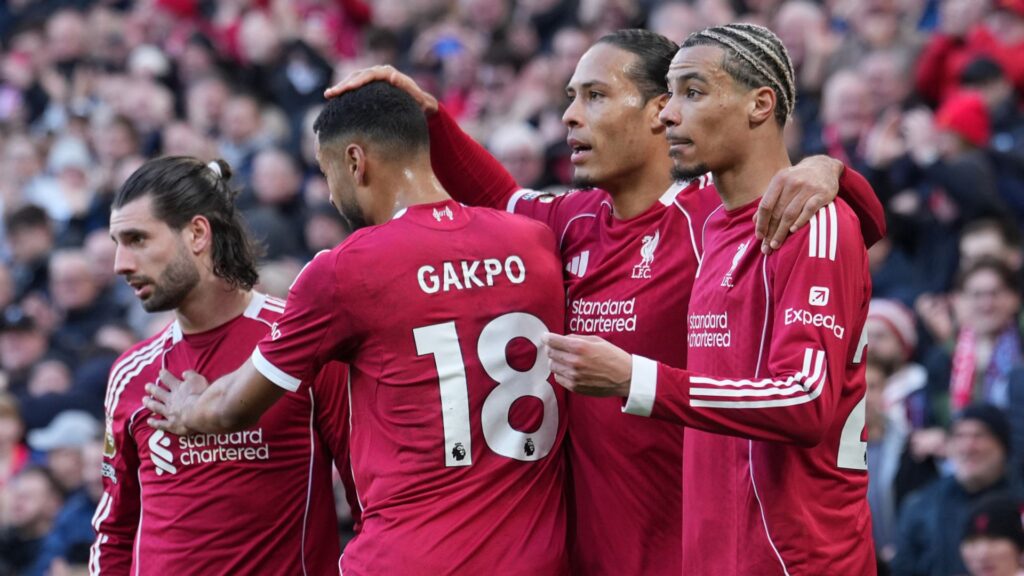 Liverpool players celebrating a goal against West Ham at Anfield during a Premier League match