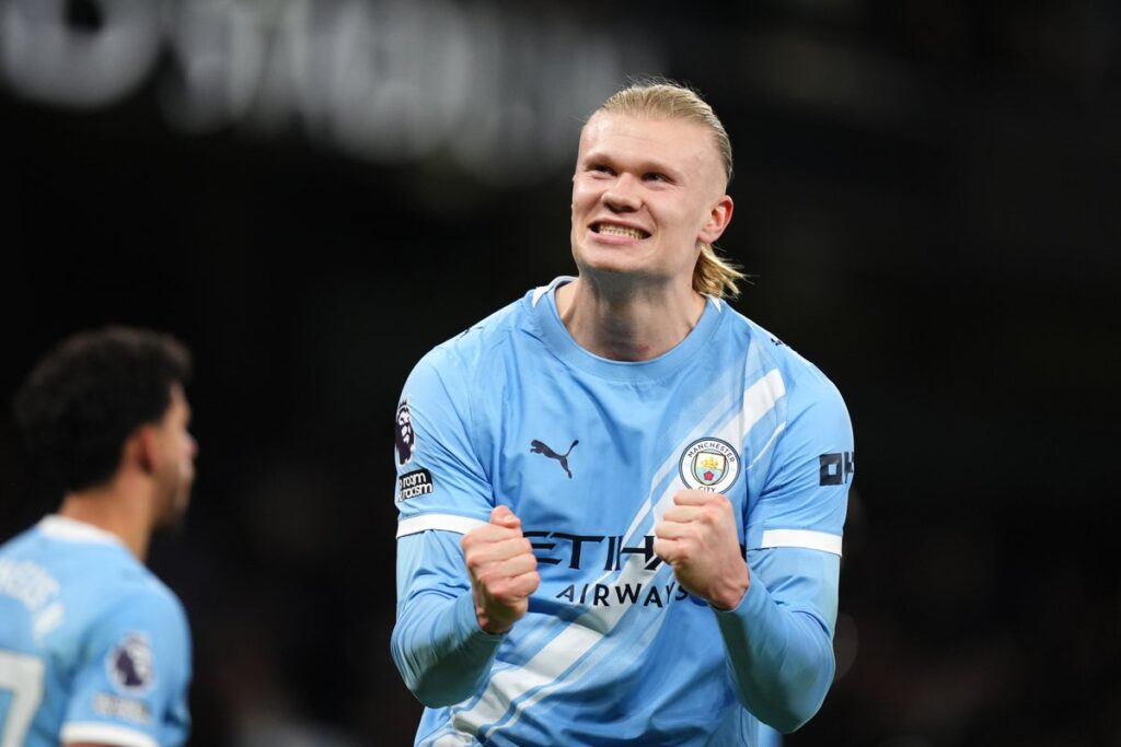 Manchester City players celebrating a goal at the Etihad Stadium
