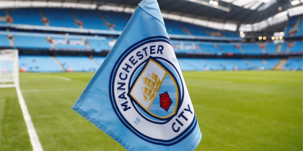 Manchester City badge on the Etihad Stadium exterior
