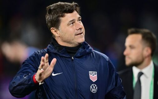 Mauricio Pochettino gesturing from the touchline while wearing a suit