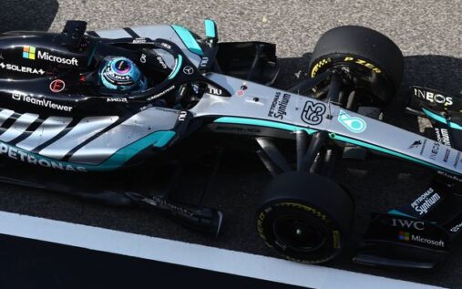 Mercedes team principal Toto Wolff looking serious while wearing team headphones in the pit lane