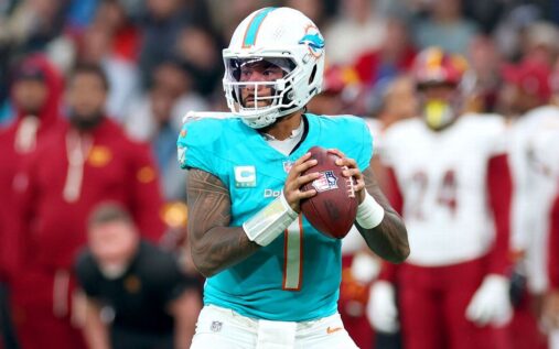 Miami Dolphins quarterback Tua Tagovailoa looking on from the sidelines during an NFL game