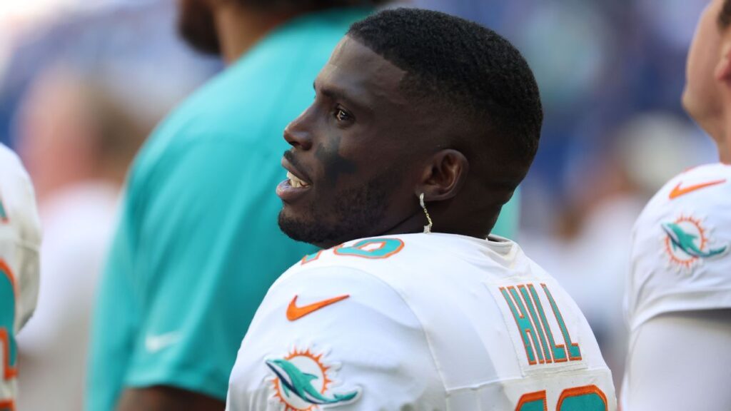 Tyreek Hill looking on from the sidelines in a Miami Dolphins uniform
