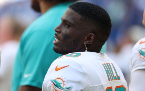 Tyreek Hill looking on from the sidelines in a Miami Dolphins uniform