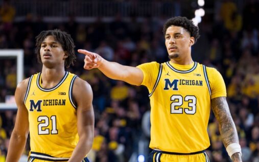 Michigan Wolverines basketball players celebrating on the court during a game