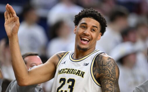 Michigan Wolverines players celebrating a victory on the basketball court during the 2025-26 season