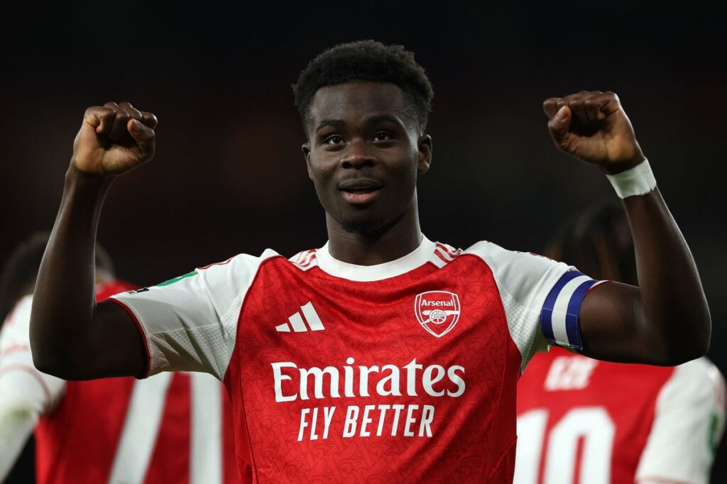 Bukayo Saka gesturing to teammates while playing for Arsenal