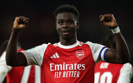 Bukayo Saka gesturing to teammates while playing for Arsenal