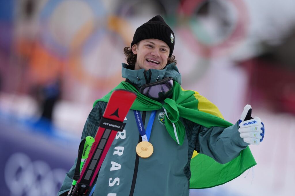 Lucas Pinheiro Braathen celebrating his gold medal win in the snow at the 2026 Winter Olympics
