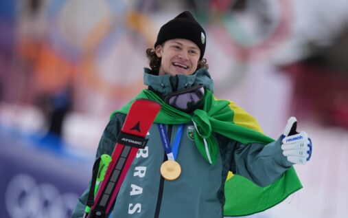 Lucas Pinheiro Braathen celebrating his gold medal win in the snow at the 2026 Winter Olympics