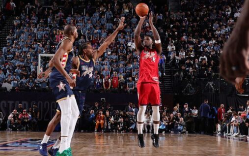 Anthony Edwards holding the NBA All-Star MVP trophy on the court at the Intuit Dome
