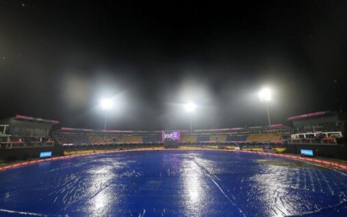 Groundstaff pulling covers onto the cricket pitch at R Premadasa Stadium in Colombo under heavy rain