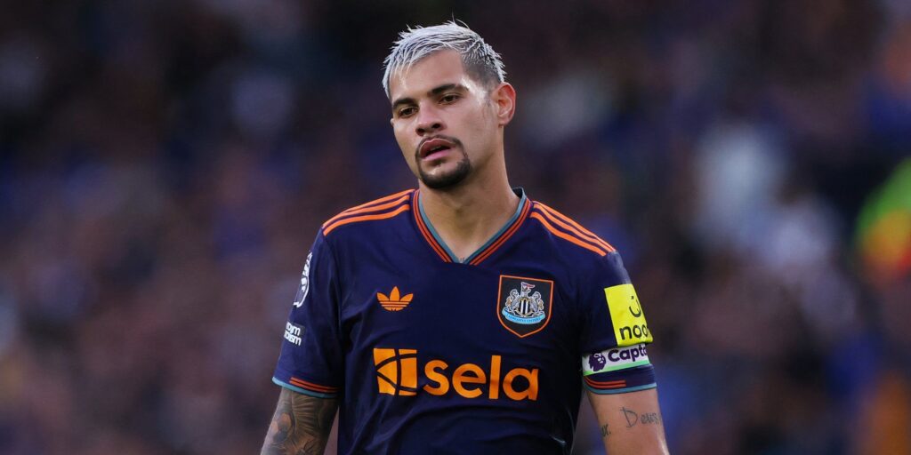 Bruno Guimaraes looking dejected while clapping the fans in a Newcastle United shirt