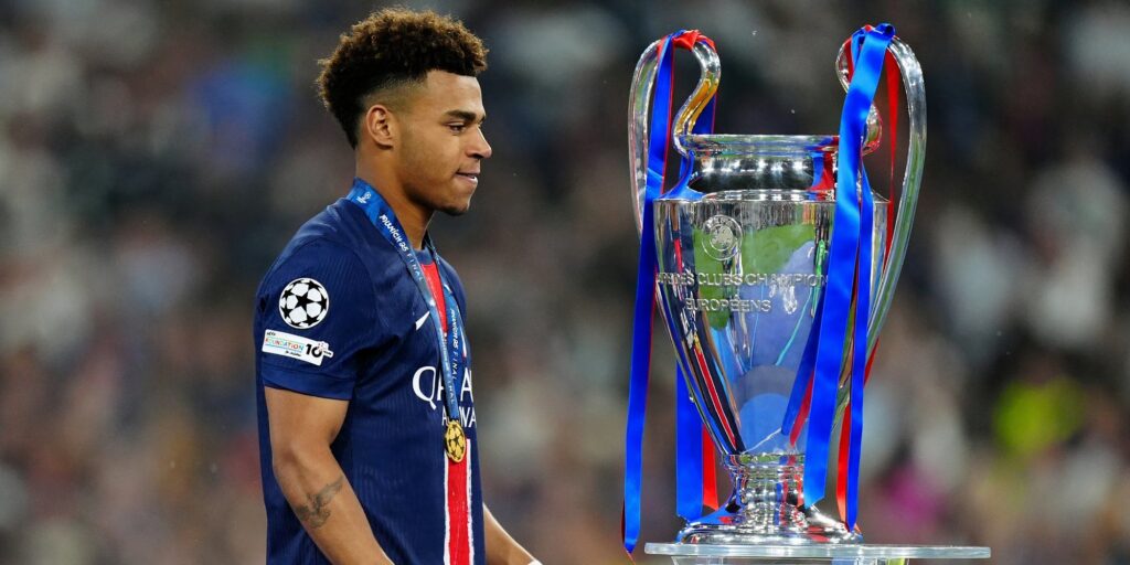 The Champions League trophy displayed on a pedestal ahead of the knockout stages