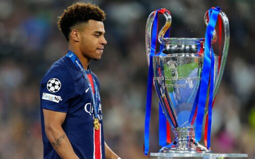 The Champions League trophy displayed on a pedestal ahead of the knockout stages